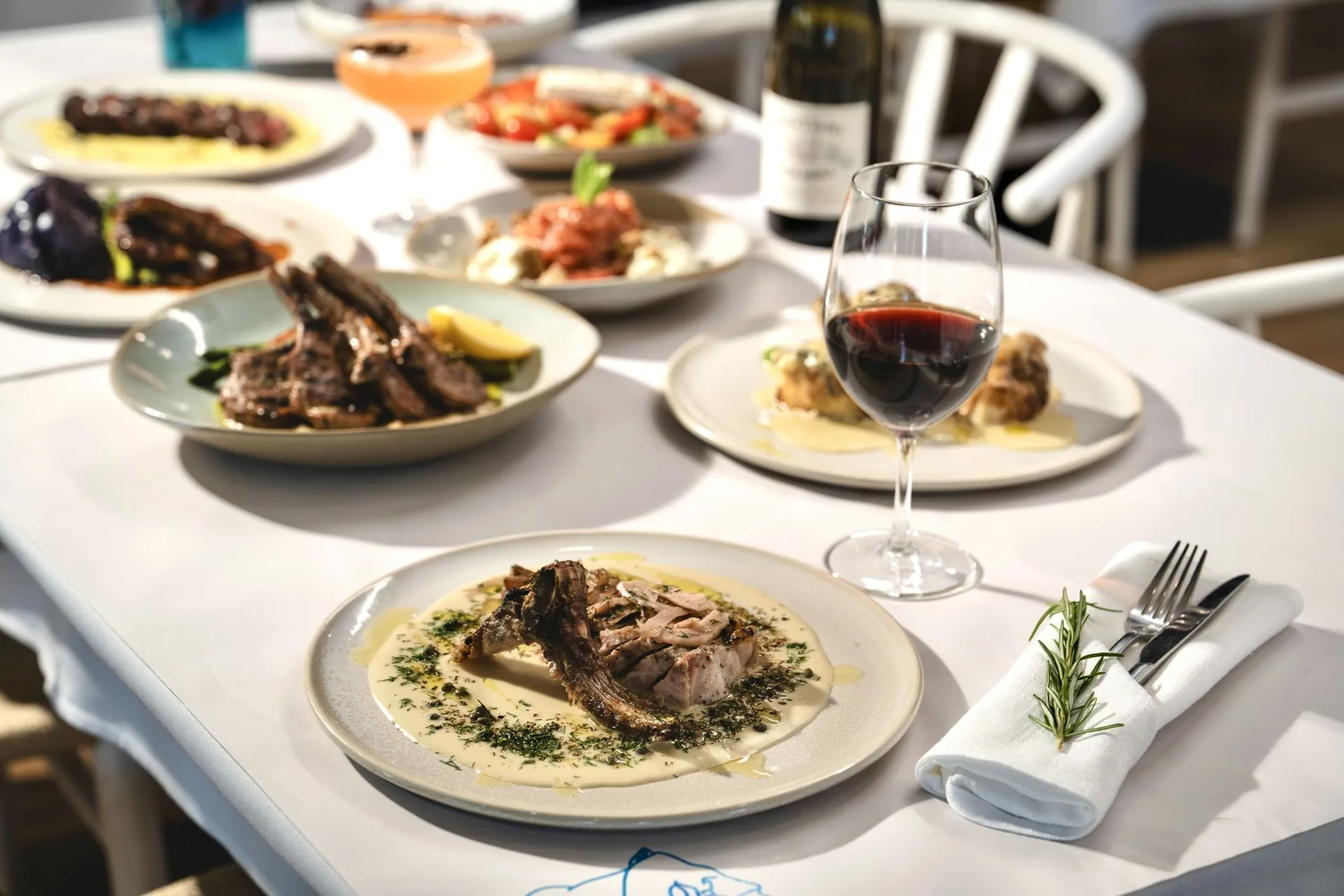 A long shared table of Greek dishes at Opa Echuca